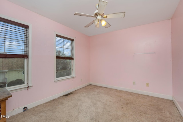 empty room featuring visible vents, ceiling fan, baseboards, and carpet floors