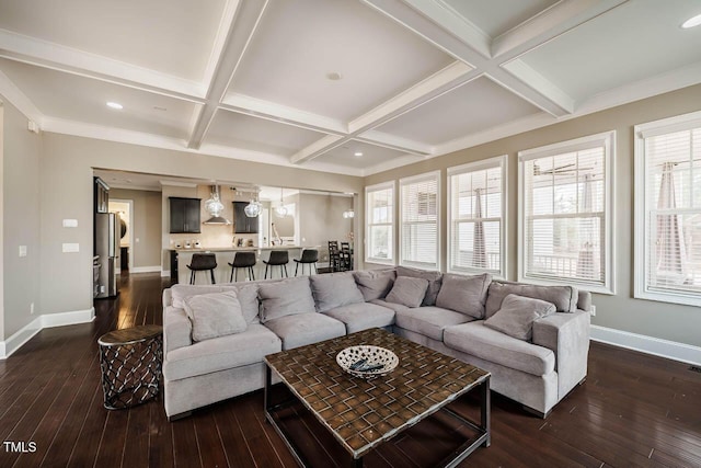 living area with baseboards, coffered ceiling, a healthy amount of sunlight, and dark wood-style flooring