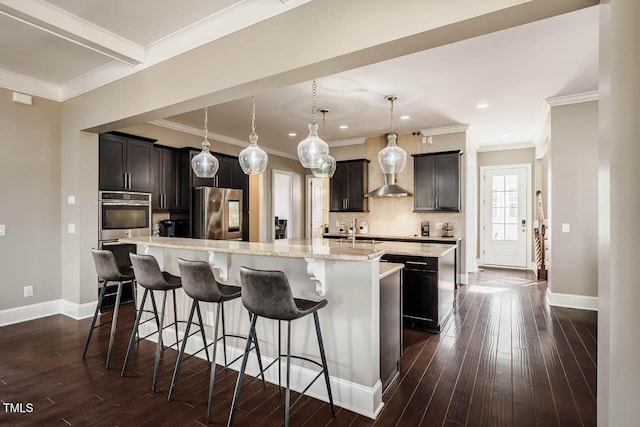 kitchen with dark wood finished floors, a large island, baseboards, and appliances with stainless steel finishes