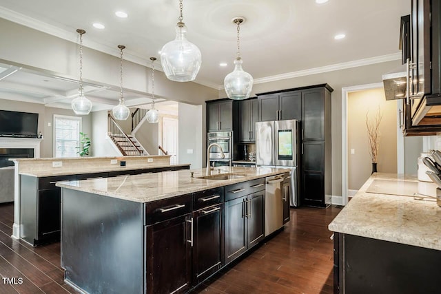 kitchen featuring a spacious island, dark wood-style floors, stainless steel appliances, and a sink