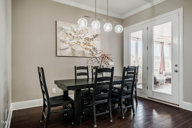 dining area with crown molding, baseboards, and dark wood-style flooring