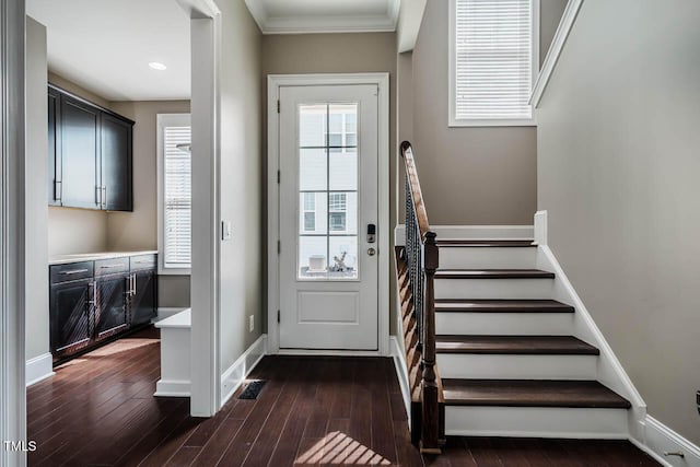 entryway with baseboards, dark wood finished floors, stairs, and ornamental molding