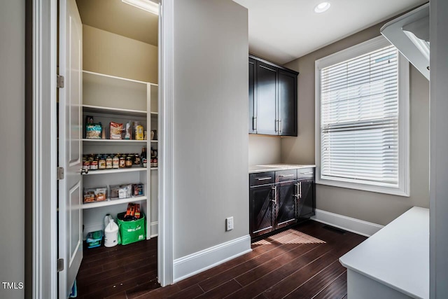 washroom featuring dark wood finished floors, recessed lighting, and baseboards