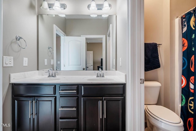 full bath featuring double vanity, toilet, and a sink