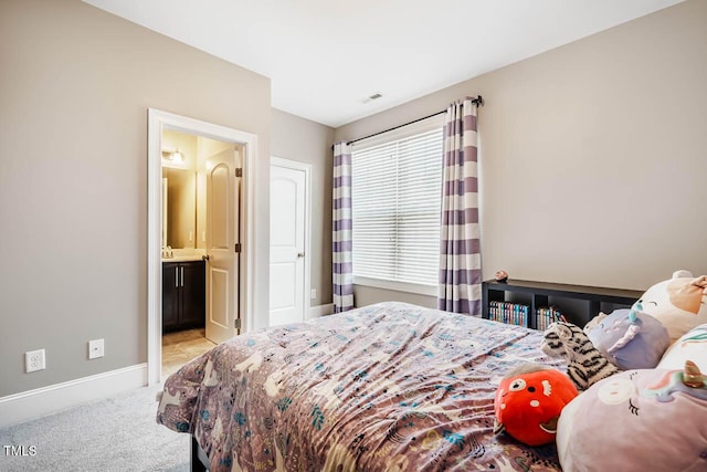 bedroom featuring baseboards, carpet floors, and connected bathroom