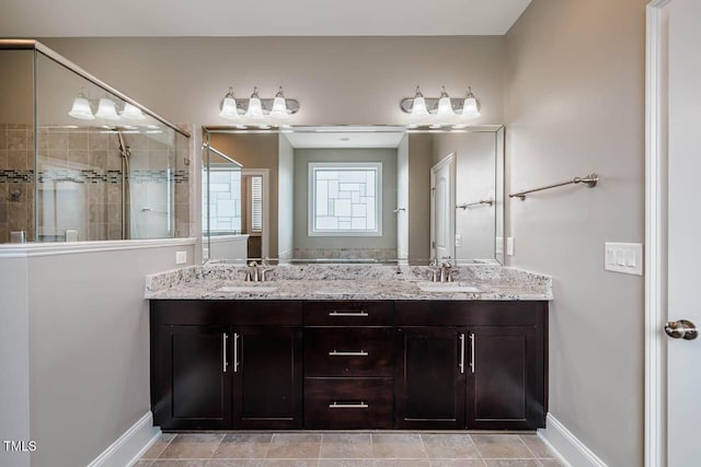 full bath with a shower stall, double vanity, and a sink