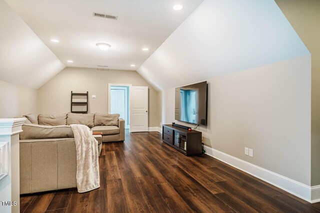 living room featuring visible vents, baseboards, lofted ceiling, recessed lighting, and wood finished floors