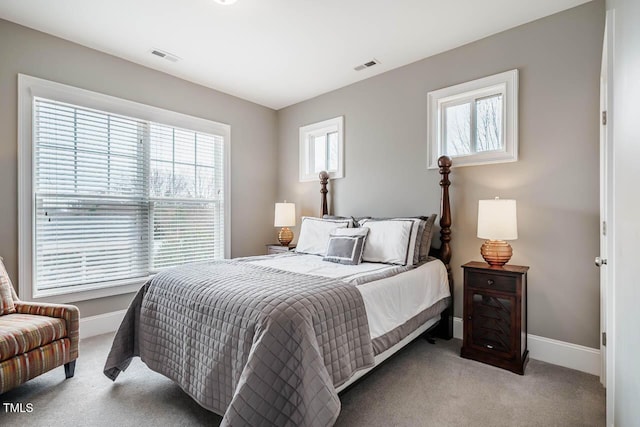 carpeted bedroom featuring visible vents and baseboards