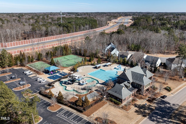 birds eye view of property featuring a wooded view