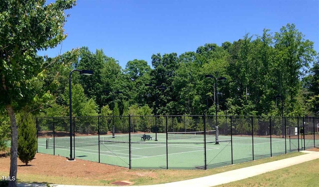 view of sport court featuring fence