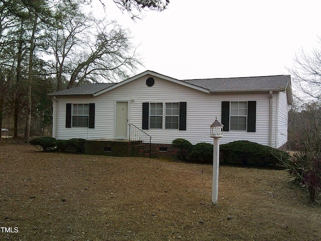 view of front of house with entry steps, crawl space, and roof with shingles