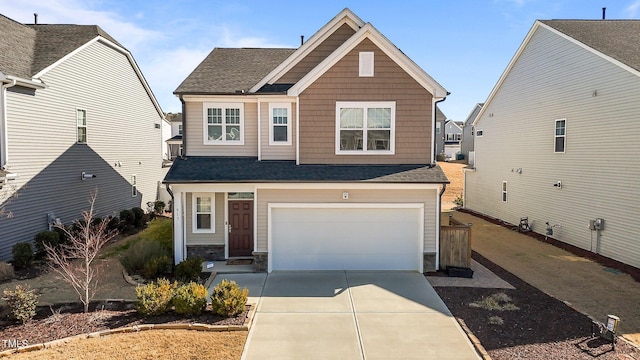 craftsman inspired home featuring a garage, stone siding, and concrete driveway