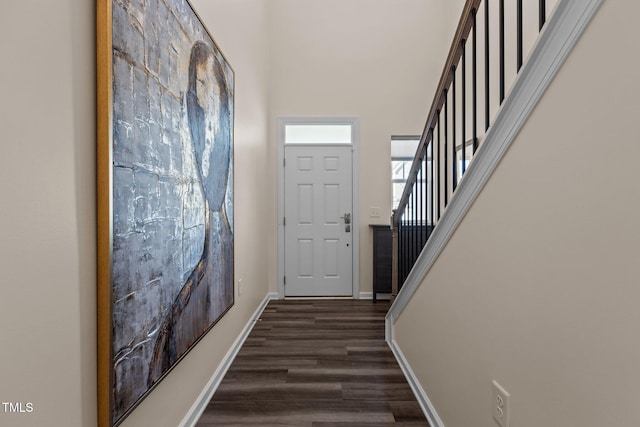 interior space with stairway, dark wood finished floors, and baseboards