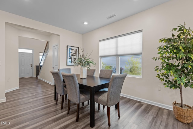 dining space with recessed lighting, wood finished floors, visible vents, and baseboards