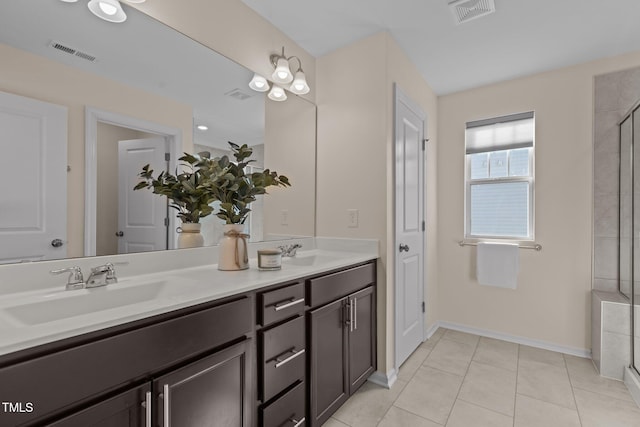 full bath with double vanity, a sink, and visible vents