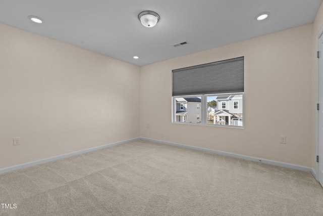 unfurnished room with carpet, visible vents, baseboards, and recessed lighting