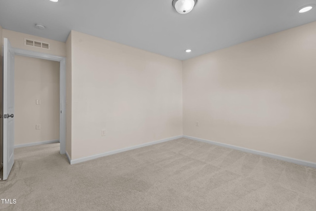 unfurnished room with light colored carpet, visible vents, baseboards, and recessed lighting