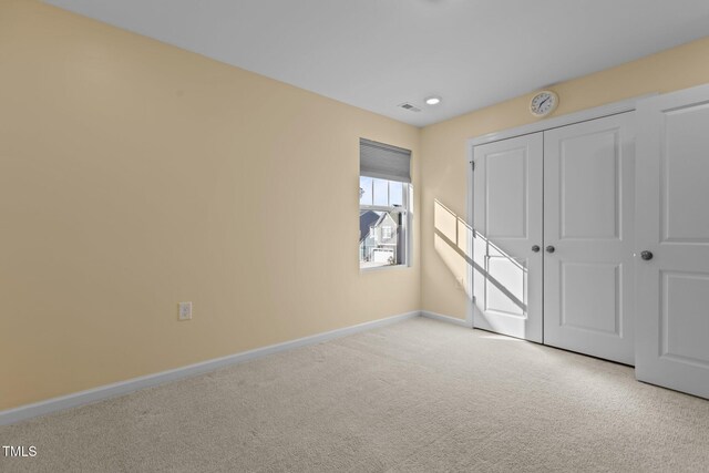 unfurnished bedroom featuring a closet, carpet flooring, and baseboards