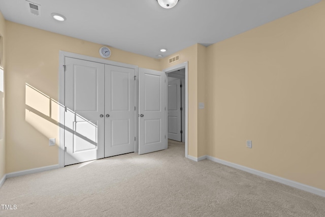 unfurnished bedroom with carpet floors, visible vents, and baseboards