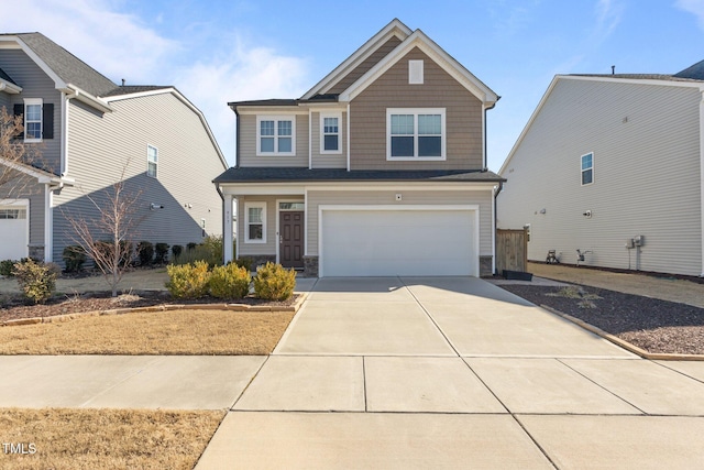 craftsman house with a garage, stone siding, and driveway