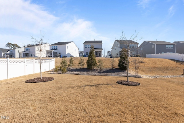 view of yard with fence and a residential view