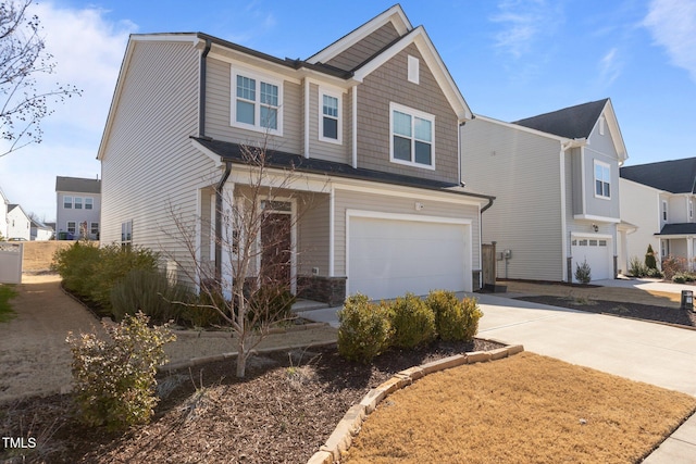 craftsman-style house featuring a garage and concrete driveway