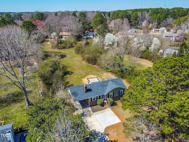 birds eye view of property featuring a view of trees