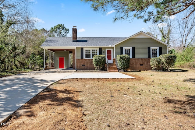 single story home with an attached carport, concrete driveway, brick siding, and a chimney