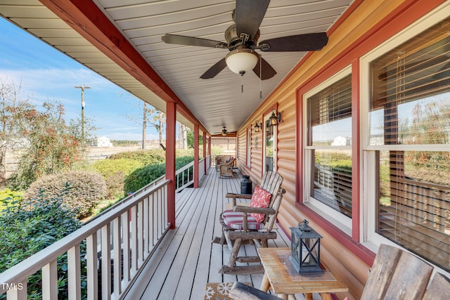 wooden deck with a porch and ceiling fan