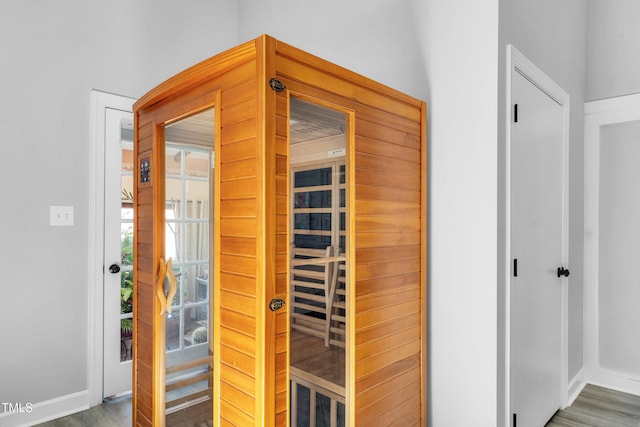 view of sauna featuring baseboards and wood finished floors