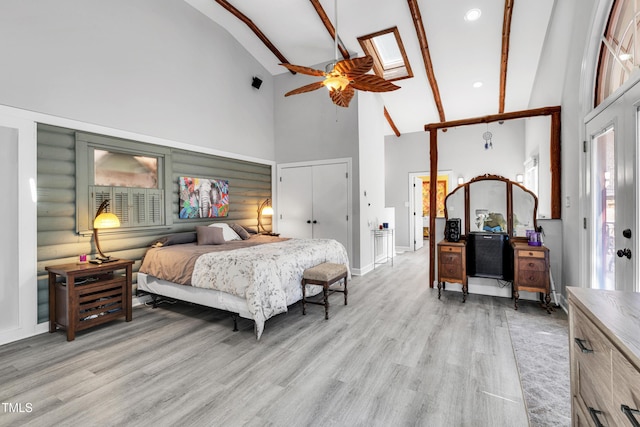 bedroom with high vaulted ceiling, light wood-type flooring, and log walls