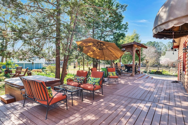 wooden terrace with a hot tub and fence