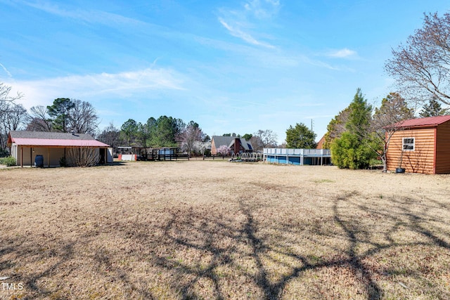 view of yard with an outbuilding and fence