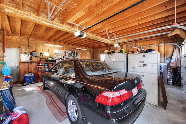 garage with freestanding refrigerator and a garage door opener