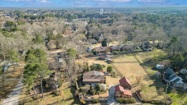 birds eye view of property with a forest view