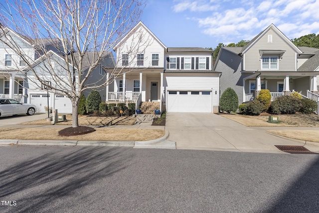 traditional home with a porch, concrete driveway, and an attached garage