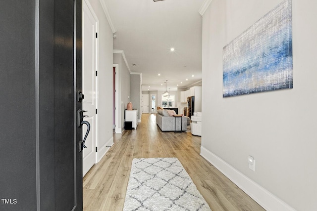 foyer entrance featuring baseboards, light wood-style floors, recessed lighting, and crown molding