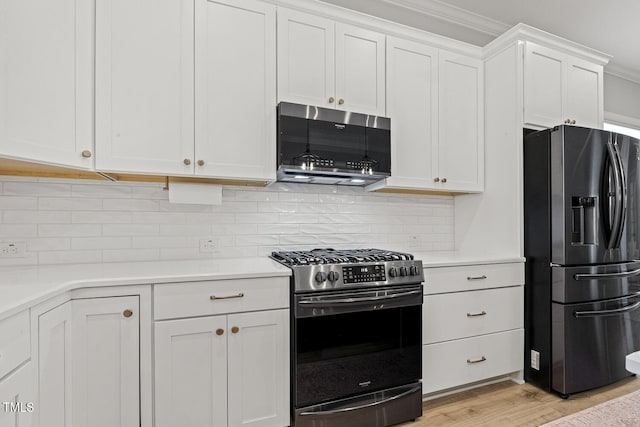 kitchen with light wood-type flooring, white cabinetry, appliances with stainless steel finishes, and light countertops