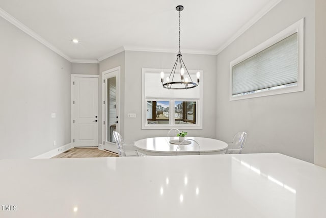 unfurnished dining area featuring light wood finished floors, baseboards, a notable chandelier, and ornamental molding