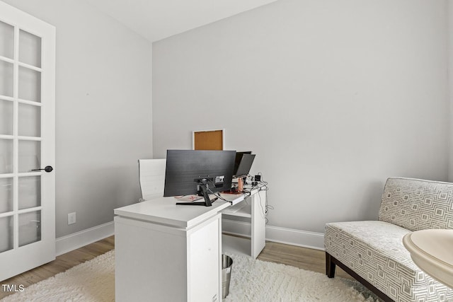 office featuring light wood-style flooring and baseboards