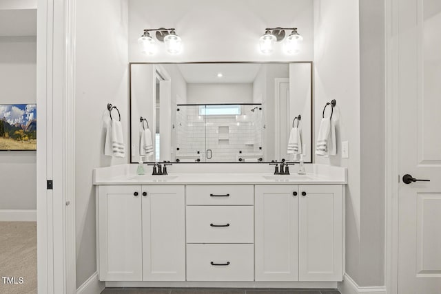 full bathroom featuring a stall shower, a sink, baseboards, and double vanity