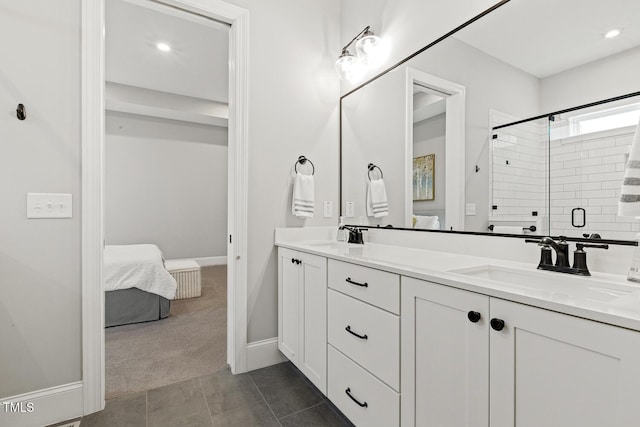 ensuite bathroom with ensuite bathroom, tile patterned flooring, a sink, double vanity, and a stall shower