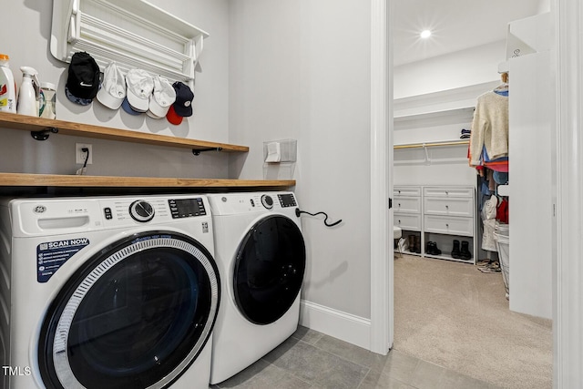 washroom featuring light tile patterned flooring, light carpet, laundry area, baseboards, and washer and clothes dryer