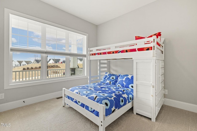 bedroom featuring baseboards, multiple windows, visible vents, and carpet flooring