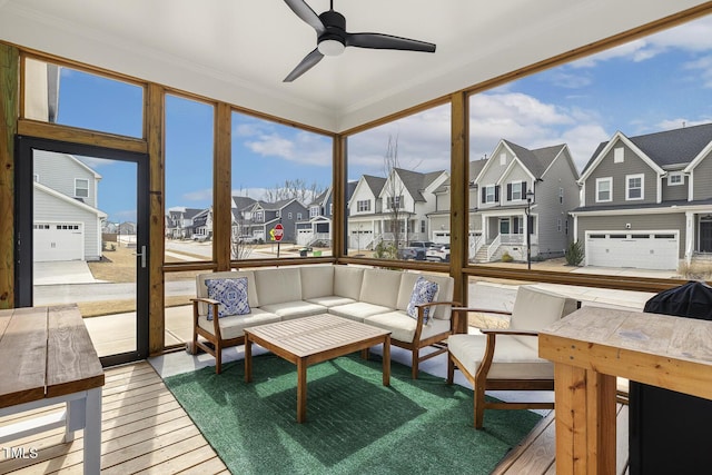 sunroom / solarium with ceiling fan and a residential view