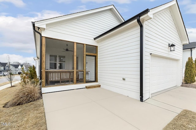 view of front of house featuring a ceiling fan, covered porch, an attached garage, and concrete driveway