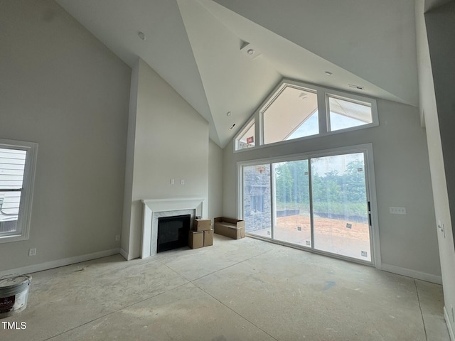 63 Daybreak Way, Fuquay Varina, NC 27526 - unfurnished living room with a fireplace, high vaulted ceiling, and baseboards