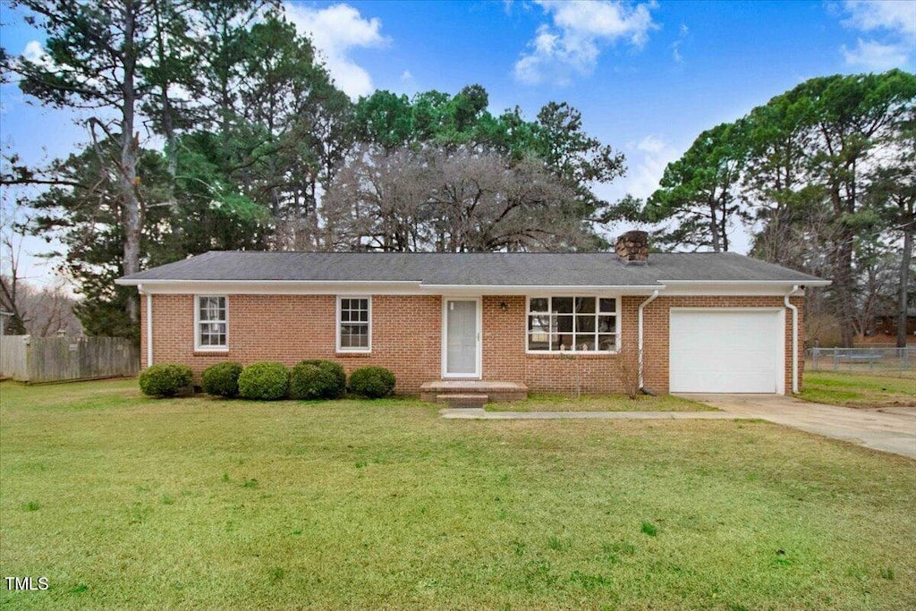 ranch-style house featuring brick siding, concrete driveway, fence, a garage, and a front lawn