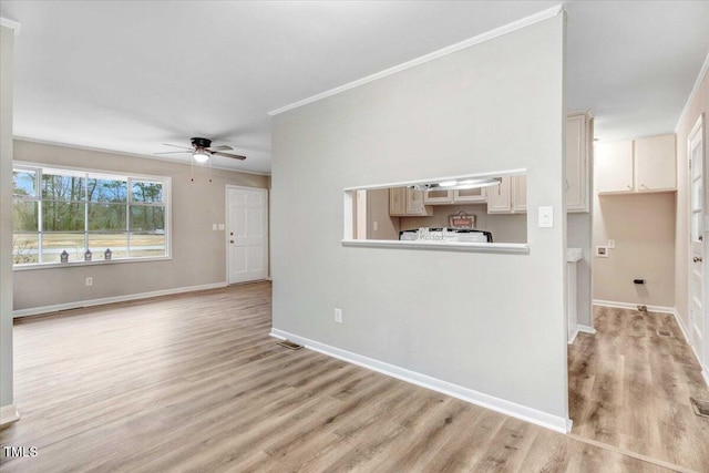 unfurnished living room featuring a ceiling fan, light wood-style flooring, and baseboards