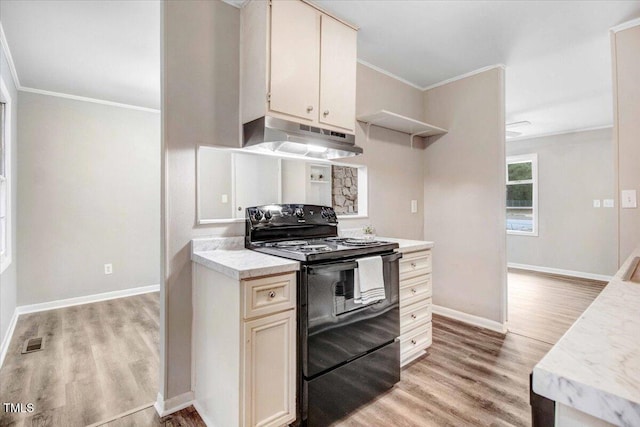 kitchen featuring under cabinet range hood, electric range, light countertops, light wood-type flooring, and crown molding